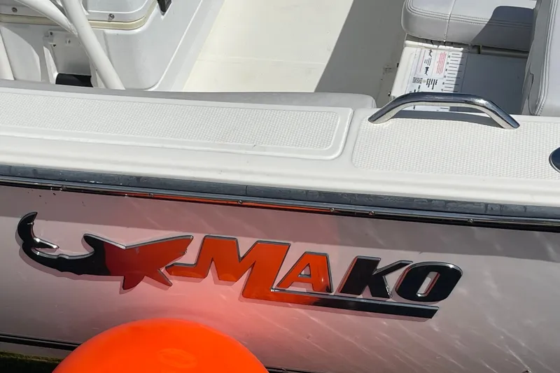 Slide: The Image of 2023 Mako 214 Center Console boat with logo and seating area. - 25