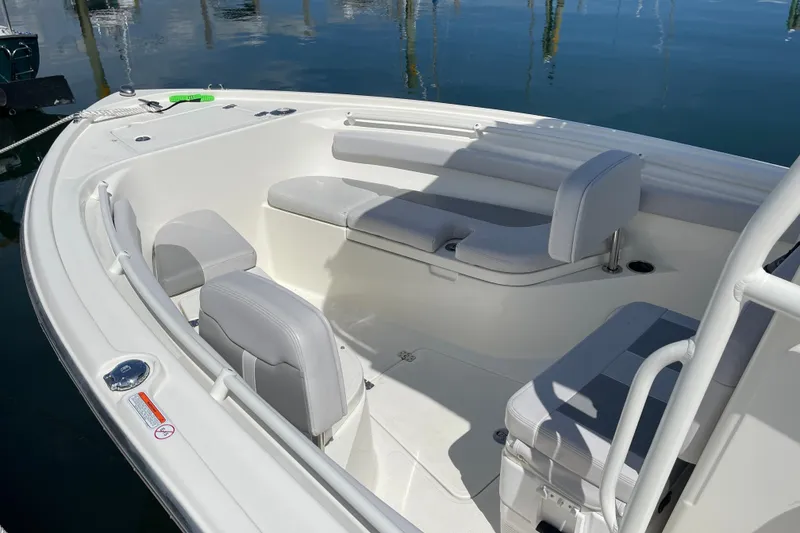 Slide: The Image of 2023 Mako 214 Center Console boat interior with cushioned seating and sleek design. - 19