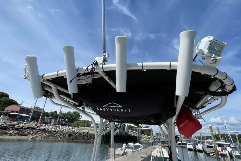 Slide: The Image of 2023 Mako 214 Center Console boat with Savvycraft canopy at marina dock. - 42