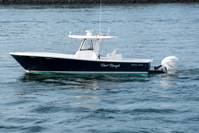 The Image of 2021 Regulator 34 boat cruising on water with twin outboard engines. - 0
