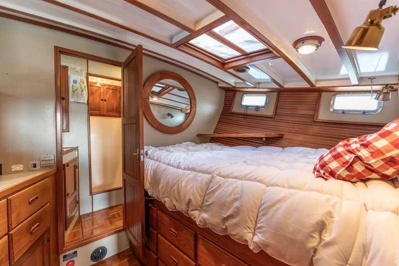 Slide: The Image of Cozy 1991 Kadey-Krogen 42 yacht cabin with wood accents and plush bedding. - 16