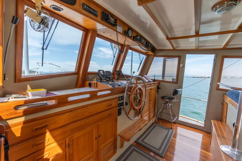 Slide: The Image of Interior of 1991 Kadey-Krogen 42 boat with wooden helm and ocean view. - 5
