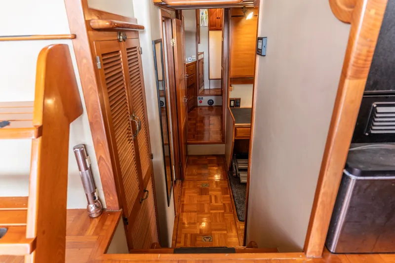 Slide: The Image of Interior of 1991 Kadey-Krogen 42 yacht with wooden finishes and narrow hallway. - 22