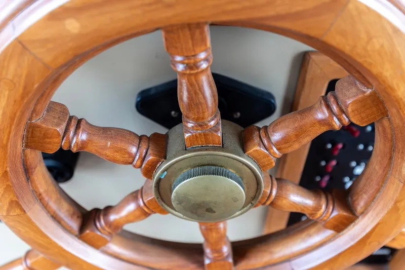 Slide: The Image of Wooden steering wheel of a 1991 Kadey-Krogen 42 boat, close-up view. - 38