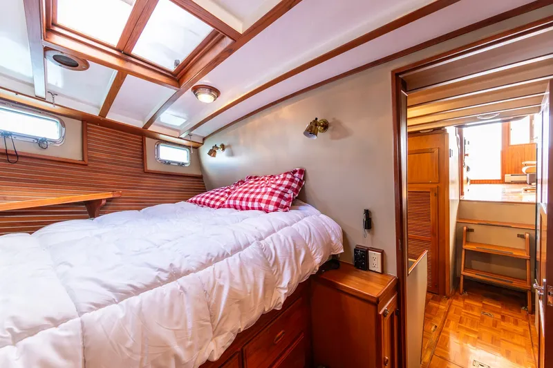 Slide: The Image of Cozy cabin interior of 1991 Kadey-Krogen 42 with wood accents and comfortable bedding. - 18