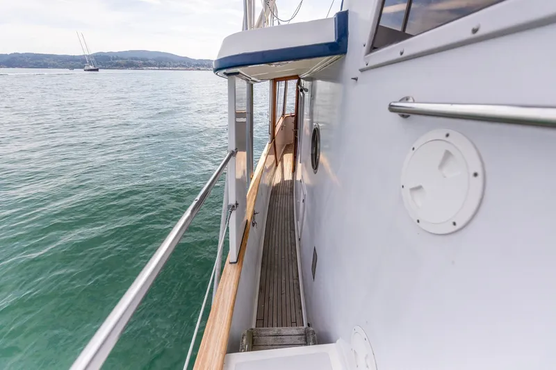Slide: The Image of Side deck view of a 1991 Kadey-Krogen 42 yacht on calm waters. - 43