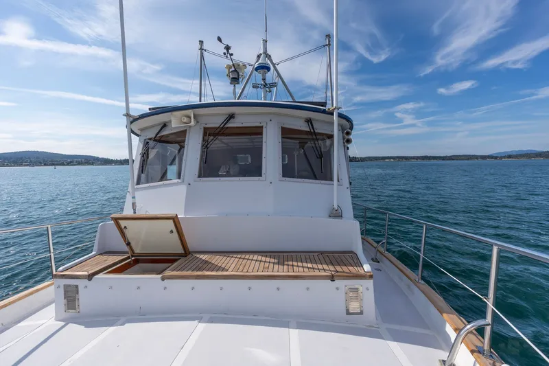Slide: The Image of Kadey-Krogen 42 yacht from 1991 on calm waters under a clear blue sky. - 45