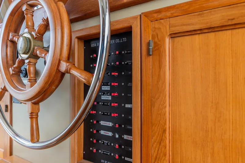 Slide: The Image of Wooden helm and control panel on 1991 Kadey-Krogen 42 yacht. - 37