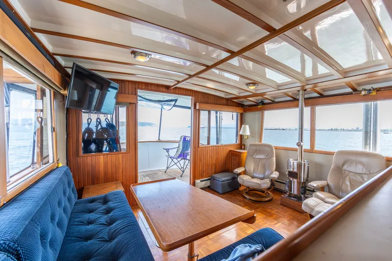 Slide: The Image of Luxurious interior of a 1991 Kadey-Krogen 42 yacht with comfortable seating and scenic views. - 6