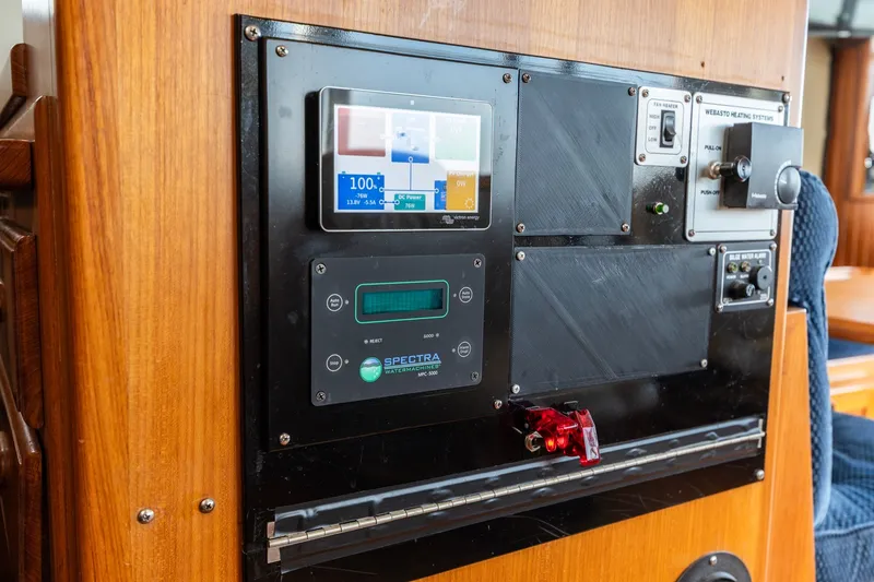 Slide: The Image of Control panel on a 1991 Kadey-Krogen 42 yacht, featuring various electronic displays and switches. - 23