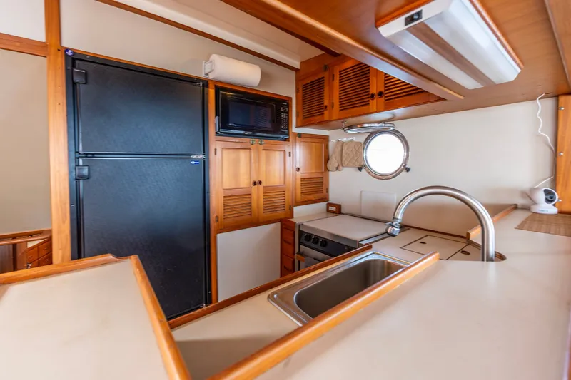 Slide: The Image of Interior of 1991 Kadey-Krogen 42 yacht kitchen with wooden cabinets and modern appliances. - 10