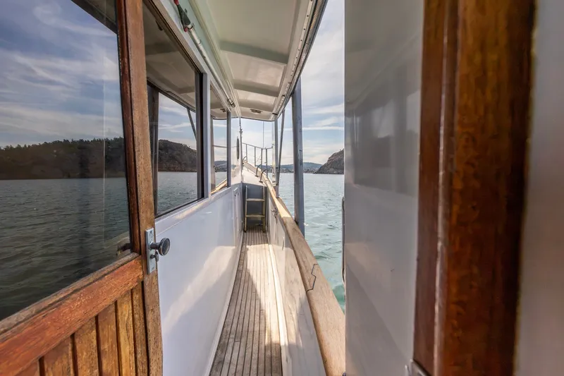 Slide: The Image of Side deck view of 1991 Kadey-Krogen 42 yacht on calm waters. - 25