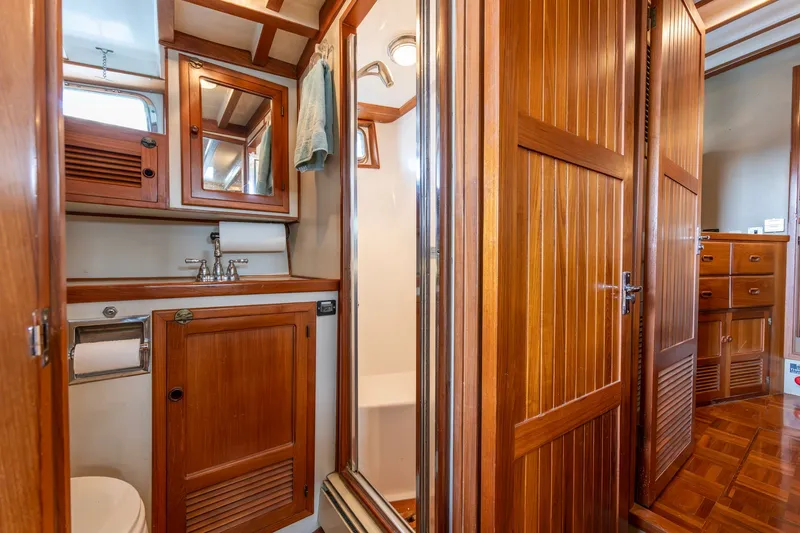 Slide: The Image of 1991 Kadey-Krogen 42 yacht bathroom with wooden cabinetry and mirror. - 15