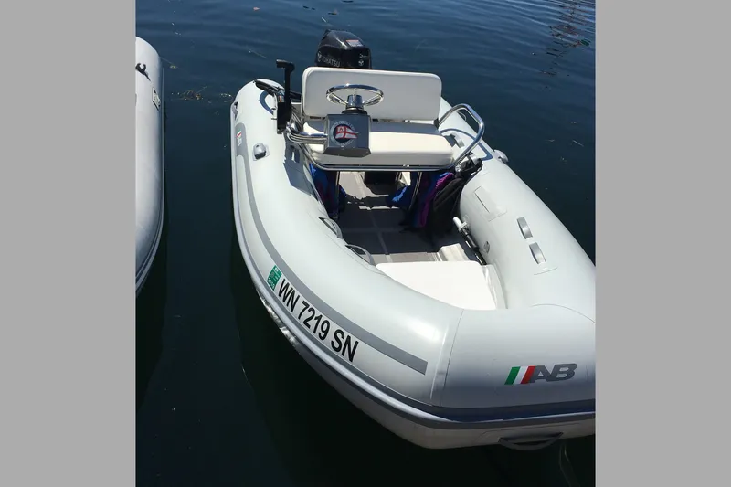 Slide: The Image of Inflatable boat on water, featuring AB logo and registration number WN 7219 SN. - 69