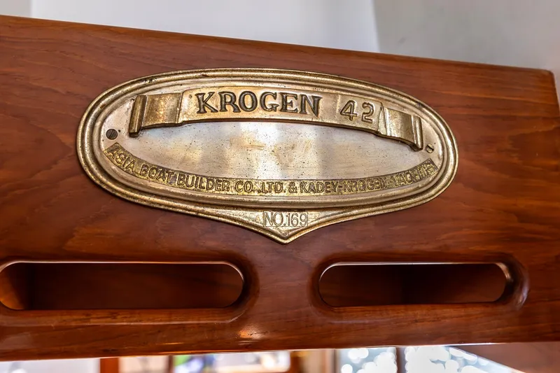 Slide: The Image of Brass nameplate of 1991 Kadey-Krogen 42 yacht on wooden surface. - 31