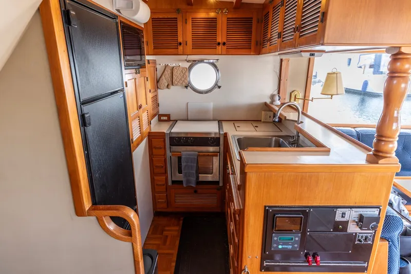 Slide: The Image of Cozy 1991 Kadey-Krogen 42 yacht kitchen with wooden cabinetry and modern appliances. - 9