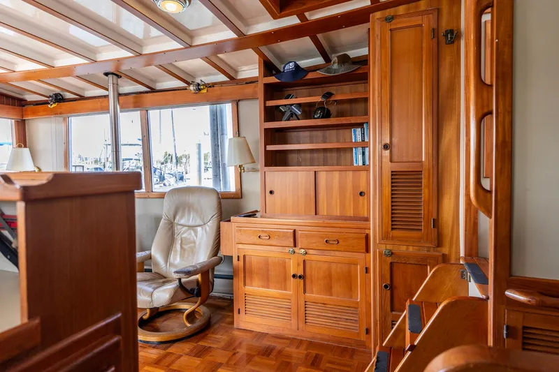 Slide: The Image of Luxurious 1991 Kadey-Krogen 42 yacht interior with wooden cabinetry and leather chair. - 11