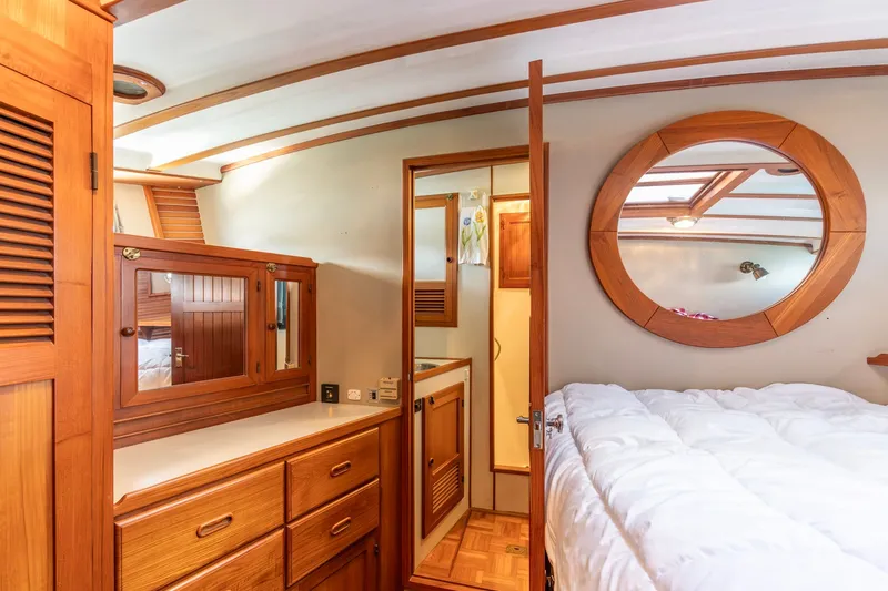 Slide: The Image of Cozy 1991 Kadey-Krogen 42 yacht cabin with wooden furnishings and round mirror. - 20