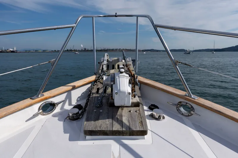 Slide: The Image of Bow view of 1991 Kadey-Krogen 42 yacht on calm waters under blue sky. - 44