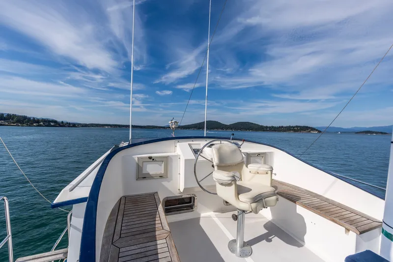 Slide: The Image of 1991 Kadey-Krogen 42 yacht helm with scenic ocean view and clear blue sky. - 53
