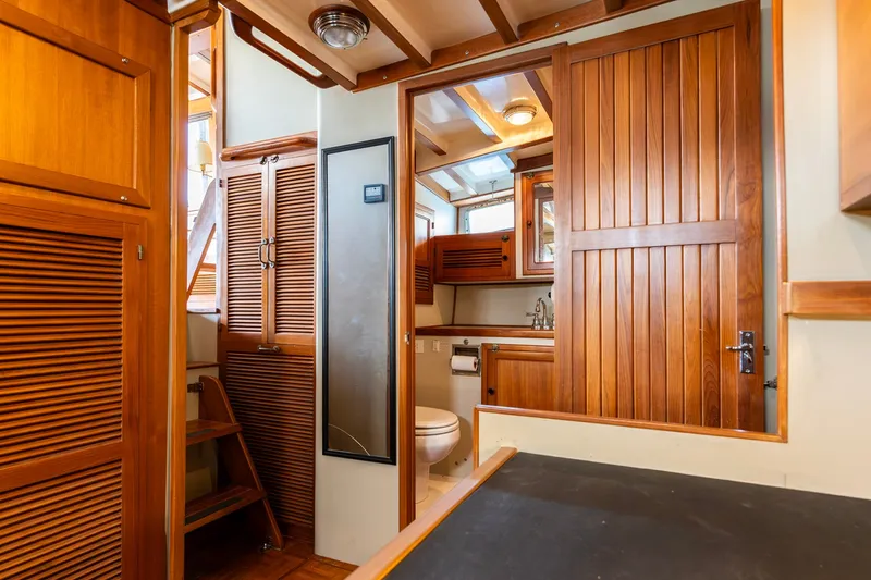 Slide: The Image of Interior of 1991 Kadey-Krogen 42 yacht with wooden cabinetry and bathroom. - 14
