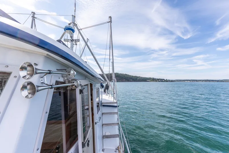 Slide: The Image of Kadey-Krogen 42 yacht cruising on serene waters under a clear blue sky, 1991 model. - 50