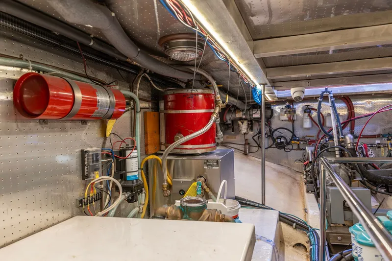Slide: The Image of Engine room of a 1991 Kadey-Krogen 42 yacht, featuring equipment and wiring. - 64