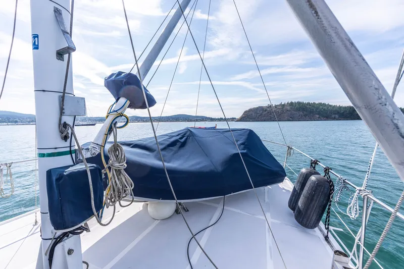 Slide: The Image of Kadey-Krogen 42 yacht deck, 1991 model, anchored near scenic coastline. - 51