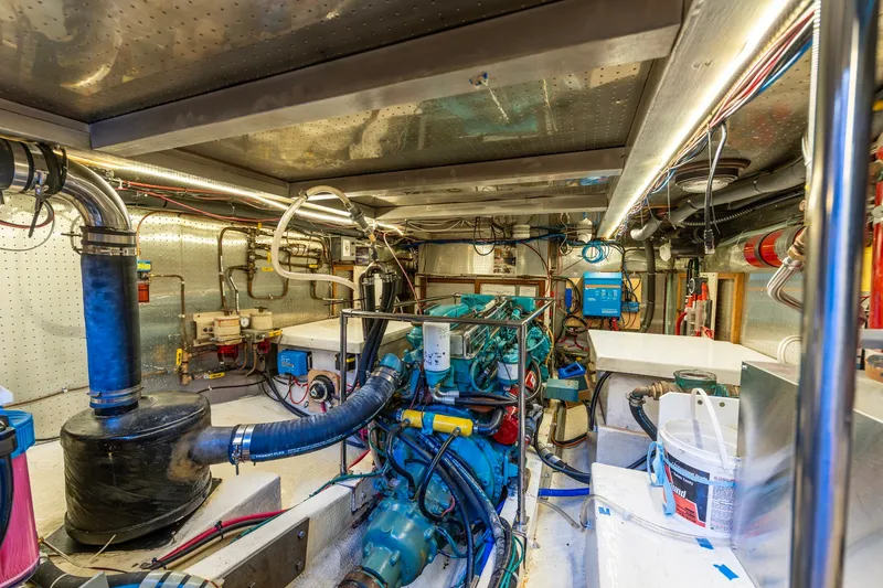 Slide: The Image of Engine room of a 1991 Kadey-Krogen 42 boat, showcasing mechanical components and wiring. - 68