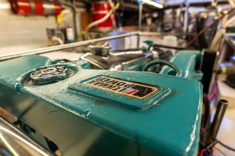 Slide: The Image of Engine room of a 1991 Kadey-Krogen 42 boat, featuring a teal-colored engine. - 63