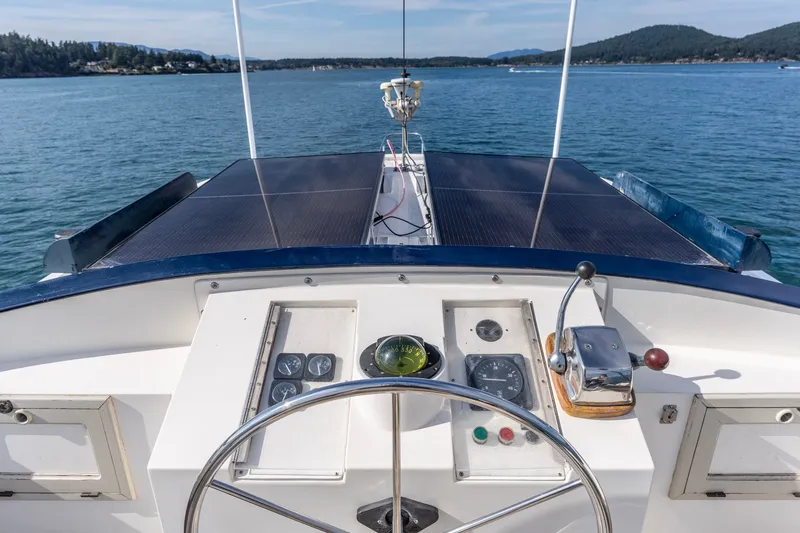 Slide: The Image of Helm of 1991 Kadey-Krogen 42 yacht with scenic ocean view. - 54