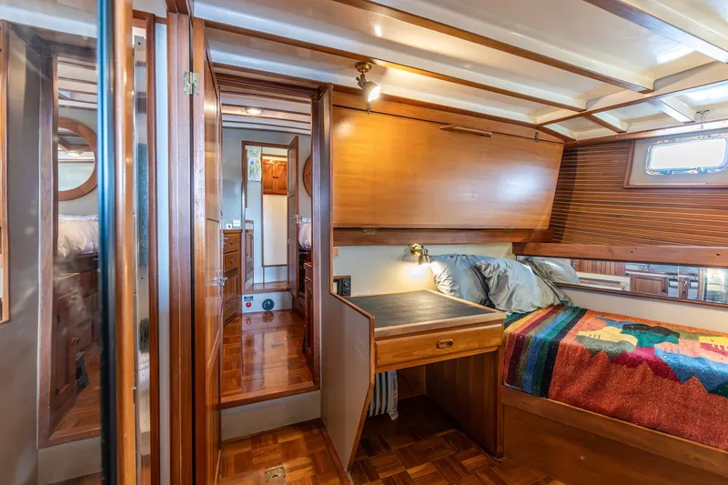 Slide: The Image of Cozy cabin interior of 1991 Kadey-Krogen 42 yacht with wooden furnishings and colorful bedding. - 12