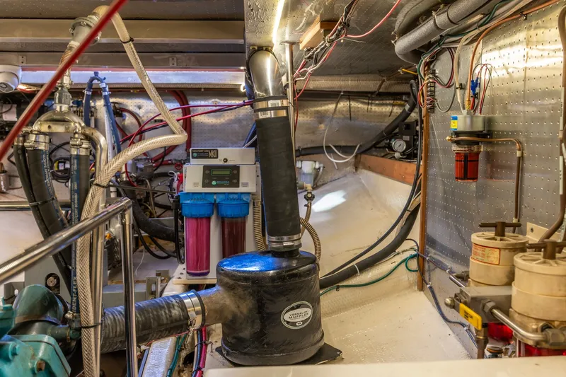 Slide: The Image of Engine room of a 1991 Kadey-Krogen 42 yacht, showcasing mechanical components and wiring. - 65