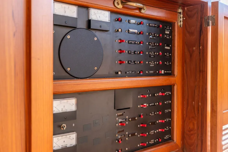 Slide: The Image of Electrical panel inside a 1991 Kadey-Krogen 42 boat, featuring gauges and switches. - 58