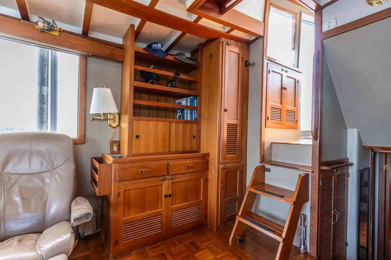 Slide: The Image of Interior of 1991 Kadey-Krogen 42 yacht with wooden cabinetry and leather chair. - 29
