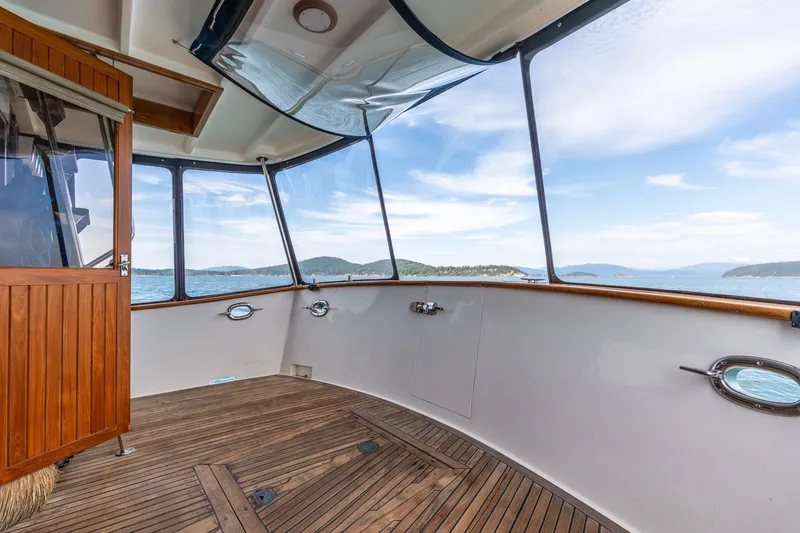 Slide: The Image of Interior view of 1991 Kadey-Krogen 42 yacht with wooden flooring and panoramic windows. - 27