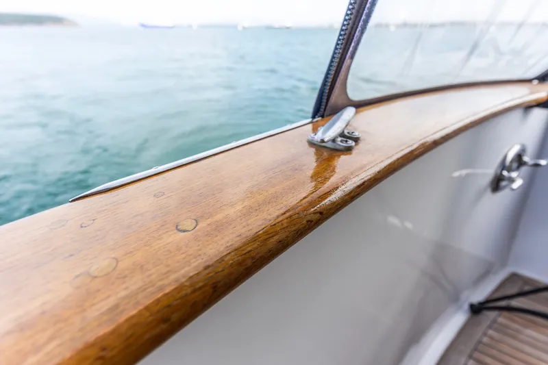 Slide: The Image of Polished wooden railing on a 1991 Kadey-Krogen 42 boat, overlooking the ocean. - 56