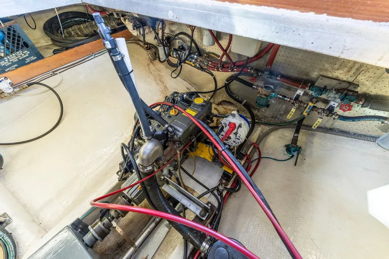 Slide: The Image of Engine room of a 1991 Kadey-Krogen 42 boat, showcasing mechanical components and wiring. - 60
