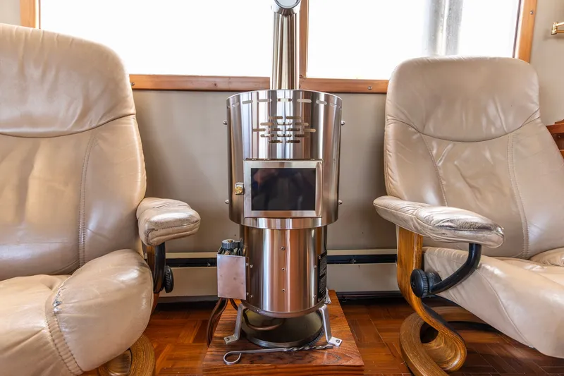Slide: The Image of Luxurious Kadey-Krogen 42 yacht interior with leather chairs and a sleek metal stove, 1991 model. - 24