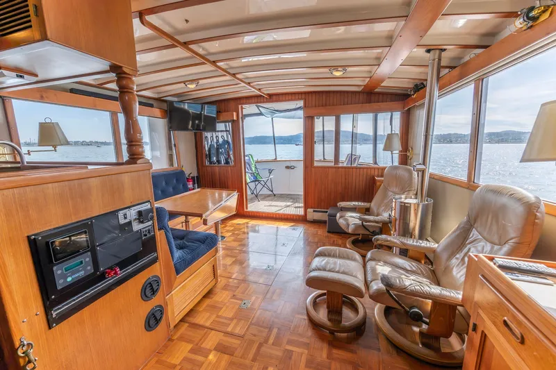 Slide: The Image of Luxurious 1991 Kadey-Krogen 42 yacht interior with wood paneling and comfortable seating. - 8