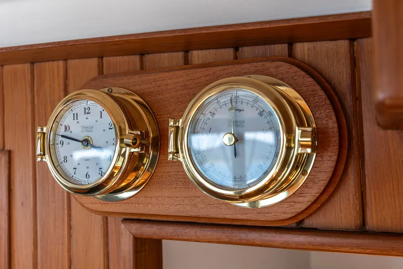 Slide: The Image of Brass clock and barometer on 1991 Kadey-Krogen 42 yacht's wooden interior panel. - 30