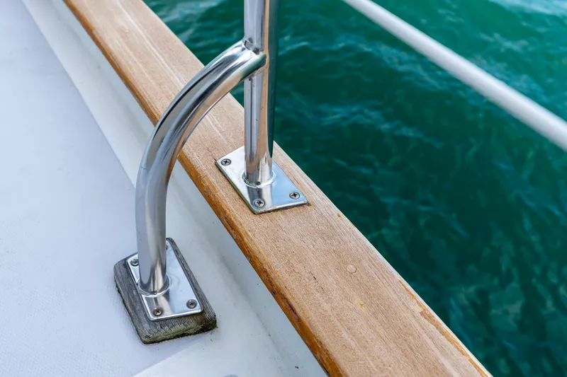 Slide: The Image of Stainless steel railing on 1991 Kadey-Krogen 42 boat, overlooking turquoise water. - 49