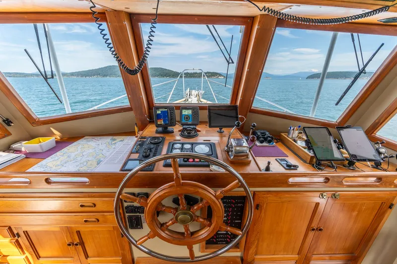 Slide: The Image of Pilothouse of a 1991 Kadey-Krogen 42 yacht with navigation equipment and scenic ocean view. - 32
