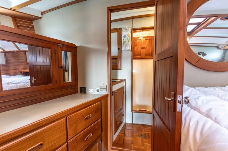 Slide: The Image of Luxurious 1991 Kadey-Krogen 42 yacht interior with elegant wood cabinetry and cozy bedroom. - 17