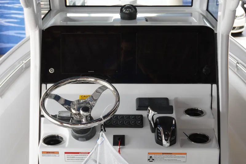 Slide: The Image of 2027 Sportsman Masters 247OE Bay Boat dashboard with steering wheel and controls. - 10