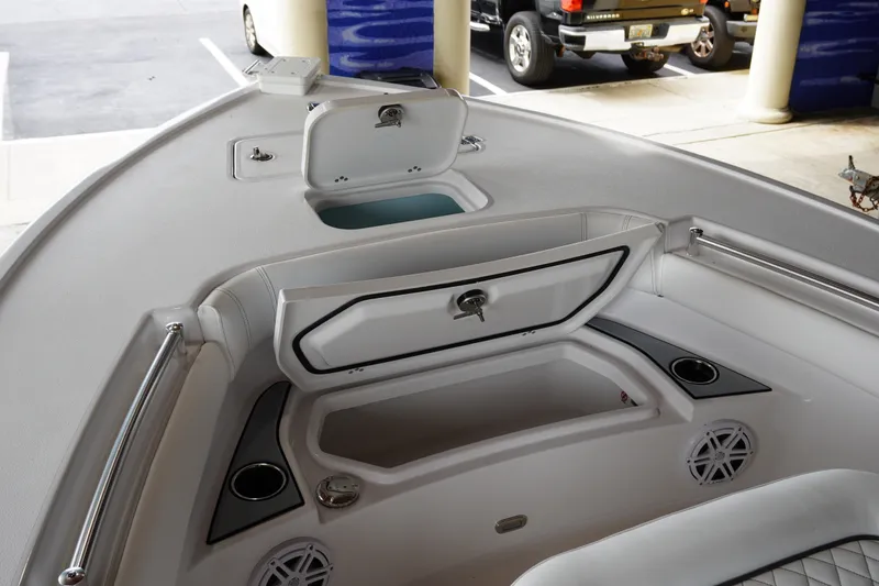 Slide: The Image of 2027 Sportsman Masters 247OE Bay Boat interior with storage compartments and cup holders. - 13