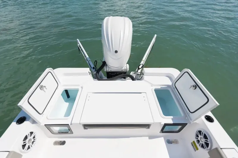 Slide: The Image of 2027 Sportsman Masters 247OE Bay Boat stern view with open storage compartments. - 6