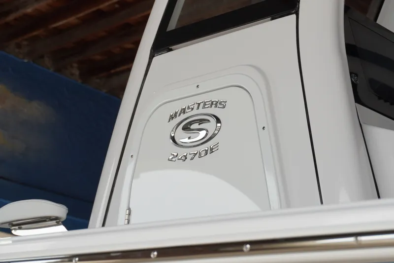 Slide: The Image of 2027 Sportsman Masters 247OE Bay Boat emblem on white surface, showcasing sleek design. - 2