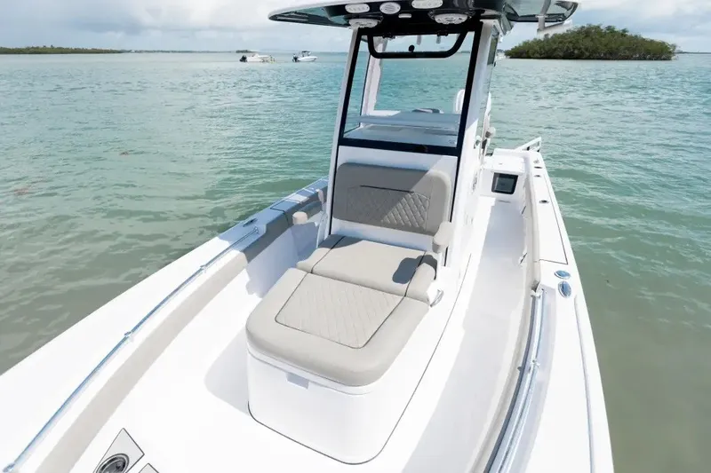 Slide: The Image of 2027 Sportsman Masters 247OE Bay Boat on calm waters, showcasing sleek design and seating. - 8