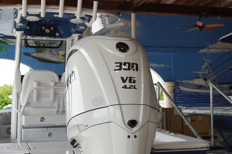 Slide: The Image of 2027 Sportsman Masters 247OE Bay Boat with Yamaha 300 V6 engine in a marina setting. - 1